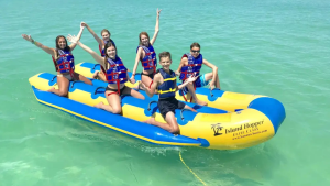 Group enjoying a banana boat ride on Siesta Key Beach in Sarasota Florida